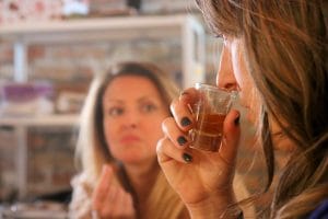 Woman smelling rakija on a private tour in Belgrade
