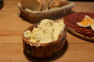 Clay pot with melting Serbian dairy kajmak