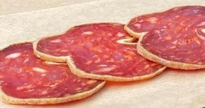 Slices of Serbian pork sausage with pepper called Kulen