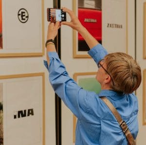 woman taking a photo at art exhibition in belgrade