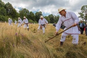 People mowing with scythes in Serbia